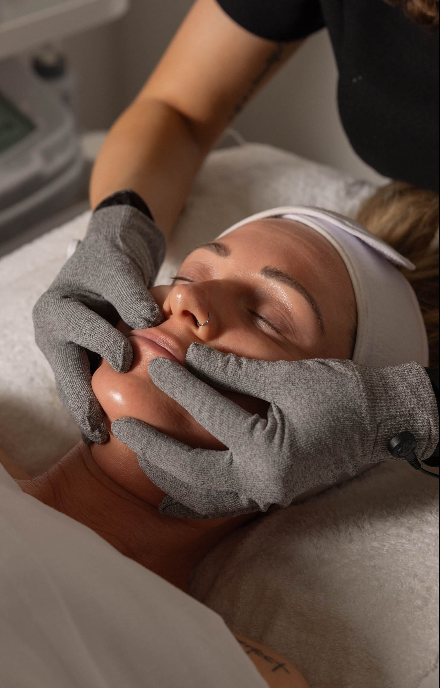 Facial contouring during LIFTED treatment using silver sculpting gloves at Vis A Vis spa