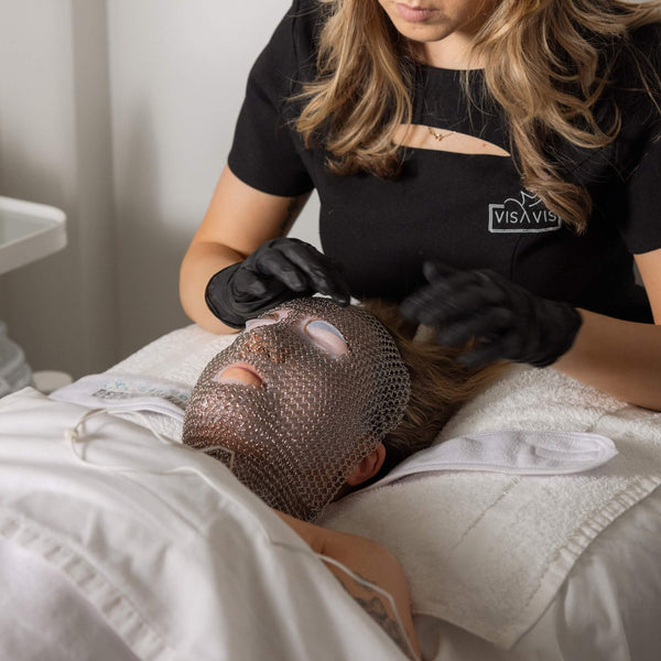 Vis A Vis esthetician applying the signature chain mask as part of the LIFTED facial treatment