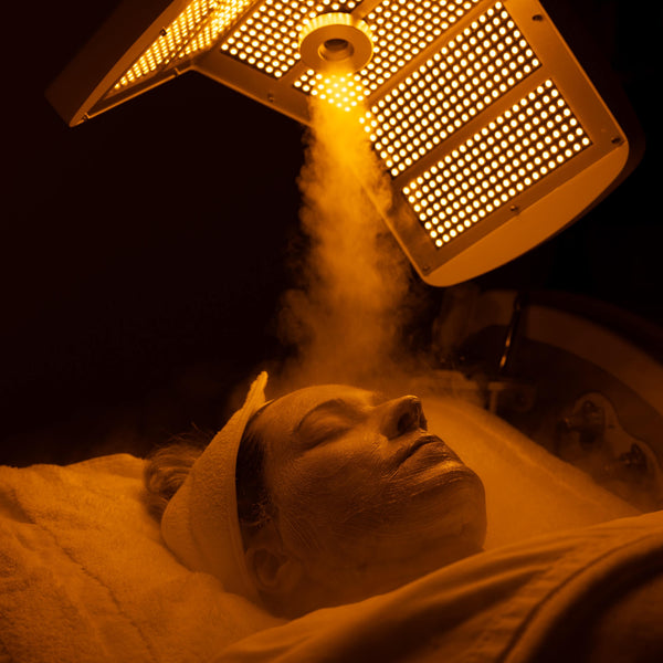 Yellow LED light and oxygen mist step in summer facial for radiant and calm skin at Vis A Vis spa.